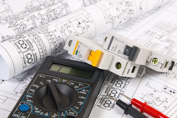 Electrical engineering drawings, modular circuit breaker and digital multimeter. Electrical network protection and switching.