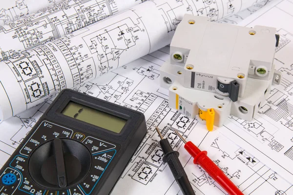 Electrical engineering drawings, modular circuit breaker and digital multimeter. Electrical network protection and switching.