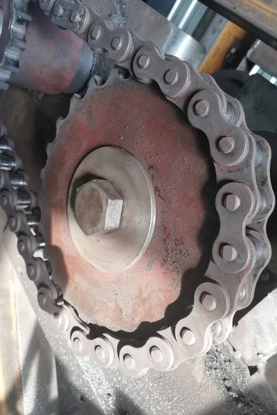 Chain drive. Driving roller chain on the drive sprocket in operation