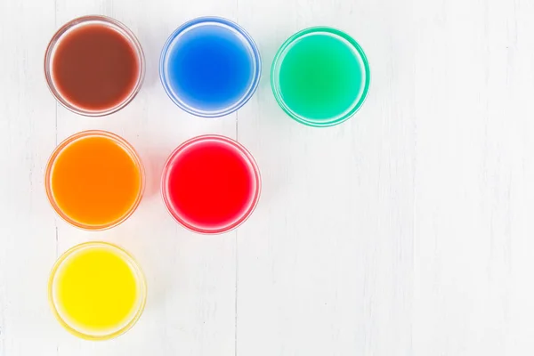 colored liquid on a white wooden background