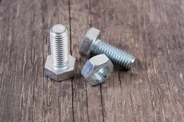 Bolt and nut on wooden background — Stock Photo, Image