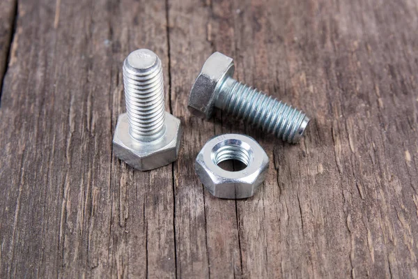 Bolt and nut on wooden background — Stock Photo, Image