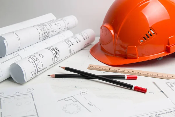 Architectural plan. Engineering house drawings, helmet, pencilsand blueprints. Stock Picture