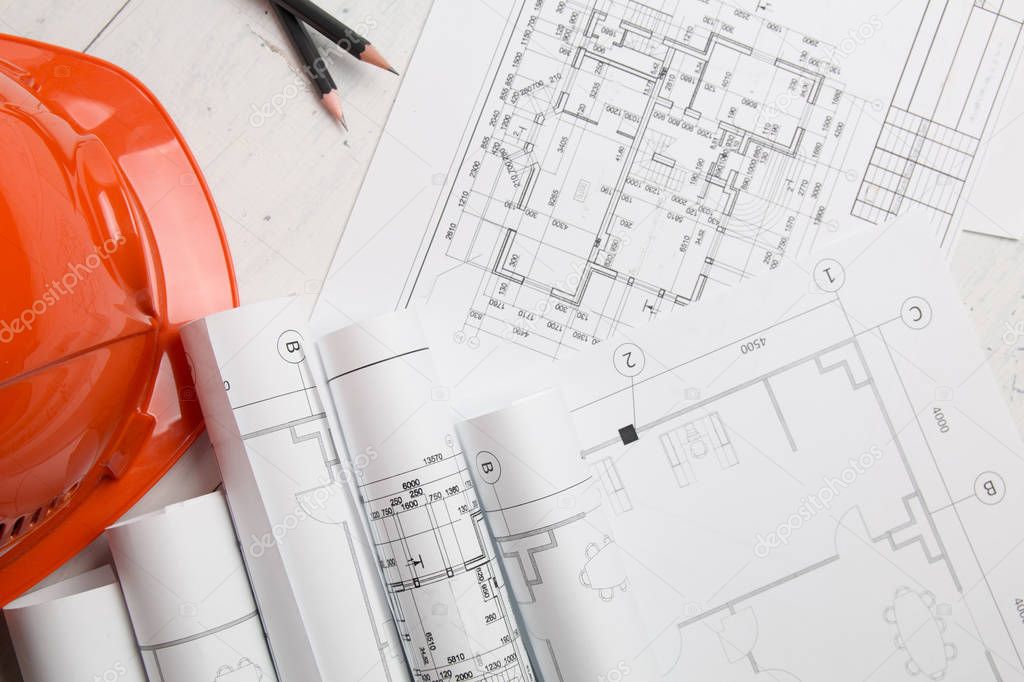 Architectural plan. Engineering house drawings, helmet, pencilsand blueprints.