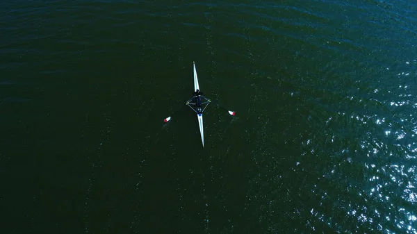 Aerial view of athlete rowing on a canoe