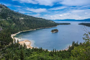 Emerald Bay view with Fannette Island in South Lake Tahoe California in the Sierra Nevada mountains. Sunshine in the summer, boats on the water clipart