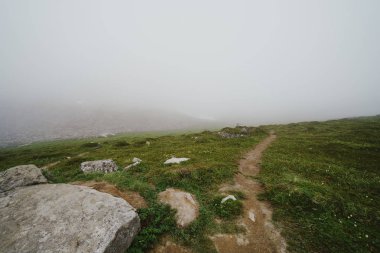 Spooky trail in the ghost town of Independence Mine Alaska at Hatcher Pass on a misty foggy day clipart