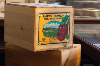 August 8 2018 - McCarthy, Alaska: Old abandoned fruit crates of apples from Washington state sit in the Kennecott Mine abandoned store clipart