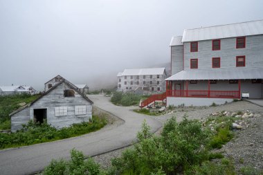 Extremely foggy view of Independence Mine in Palmer Alaska along Hatcher Pass. Considered a ghost town clipart