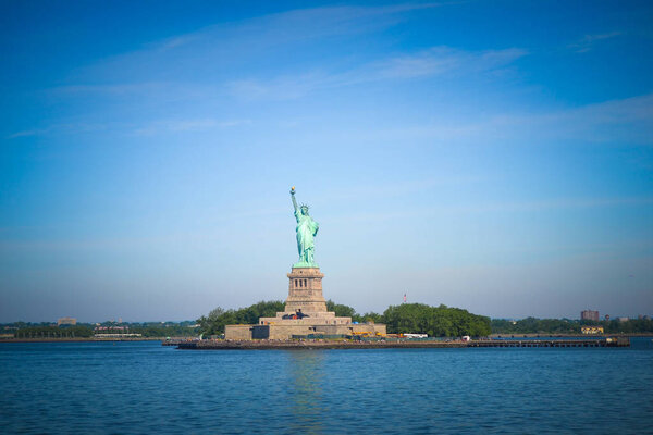 Wide angle view of the Statue of Liberty in New York City as seen from Hudson River Bay