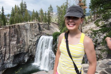 Aktif kadın uzun yürüyüşe çıkan kimse pozlar gökkuşağı Falls Devils Postpile Ulusal Anıt içinde California tarafından uygun