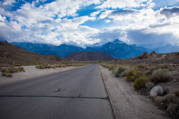 Alabama Hills Recreation Area in Lone Pine California - road through the area with weird rocks and boulders. An approaching storm enters the area