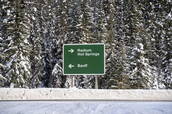 Directional road sign along Highway 93 (Banff-Windemere Highway) shows which way to Banff and Radium Hot Springs for drivers