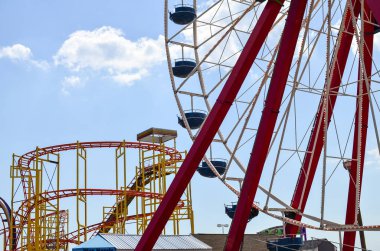 Ocean City, Maryland - April 3, 2018:  Ferris wheel and rides at the Ocean City Boardwalk in Maryland clipart
