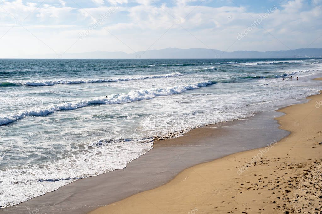 Sandy beach in Manhattan Beach California. Waves roll in