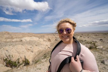 Woman tourist (20s) poses at the Borrego Badlands overlook in An clipart
