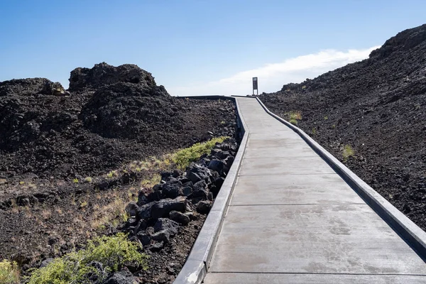 The Snow Cone trail, a paved walkway leading to a cinder cone wi
