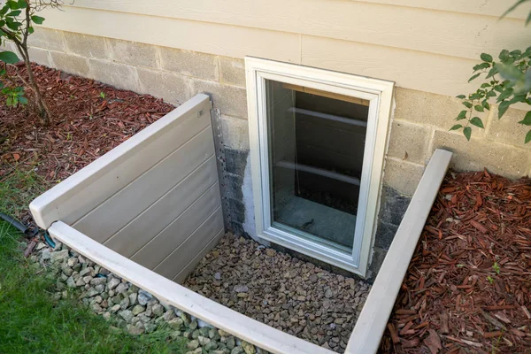 Exterior view of an egress window in a basement bedroom. These w — Stock Photo, Image