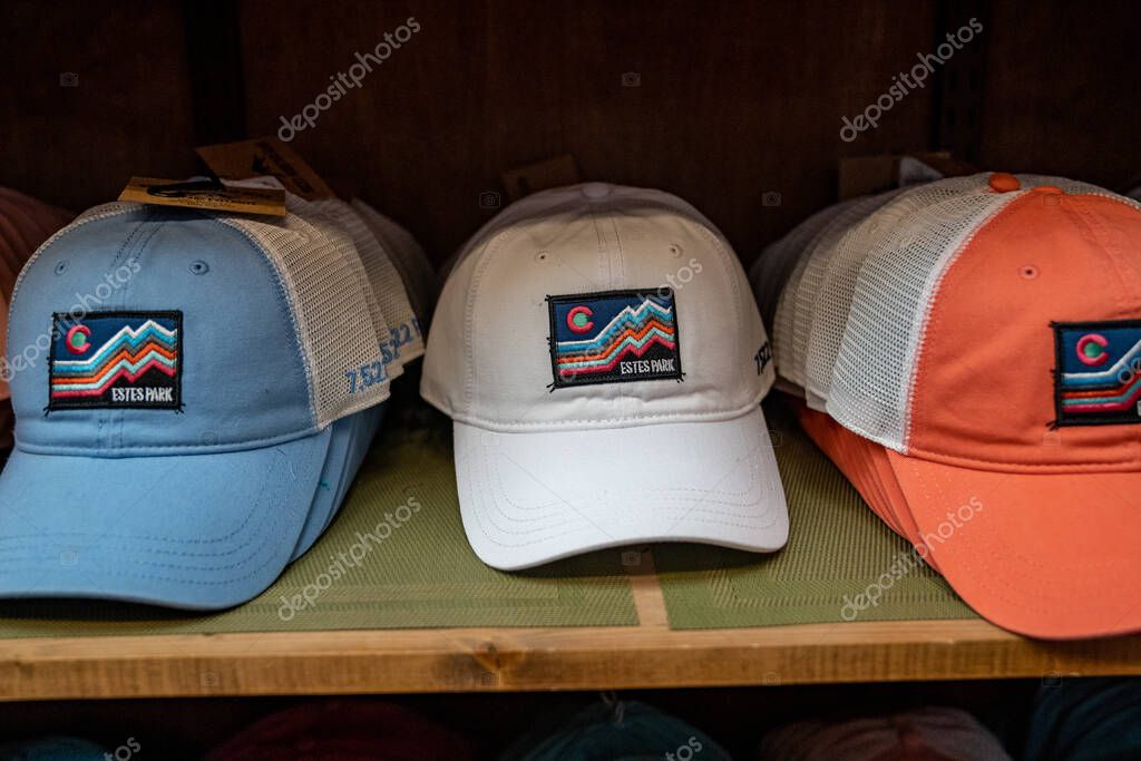 Estes Park, Colorado - September 19, 2020: Estes Park tourist hats for sale on a shelf in a gift shop in the downtown area. Only one hat in focus, intentionally