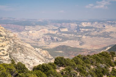 Hazy sky view of the canyon area of Dinosaur National Monument in Colorado clipart