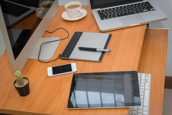 Office workplace with laptop and smartphone on wood table