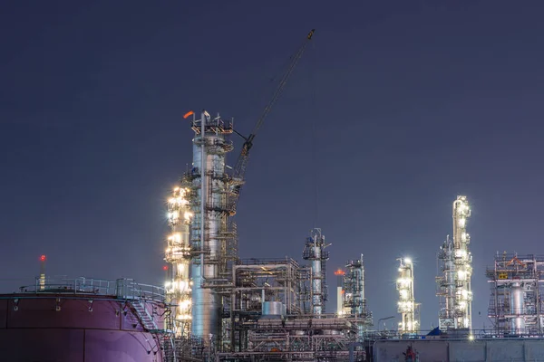 Oil refinery at night, industrial factory architecture