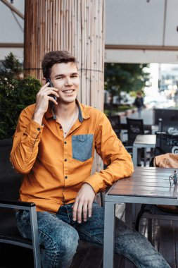 Şık giyinmiş genç adam Varşova sokaklarında. Kent merkezindeki adam. Avrupa şehir seyahat. Evrak çantalı adam. Adam tablo ve çağrıları oturuyor. Adam elini dalgalar ve hoş geldiniz.