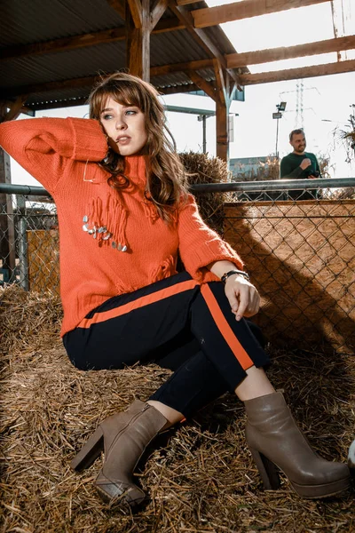 Young woman on a pumpkin farm. Beautiful girl near pumpkins. A girl with a pumpkin. Pumpkin Field.