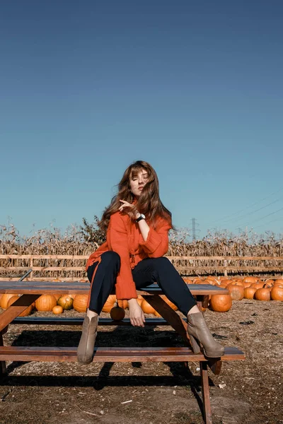 Young woman near corn. beautiful girl in the village. Autumn.