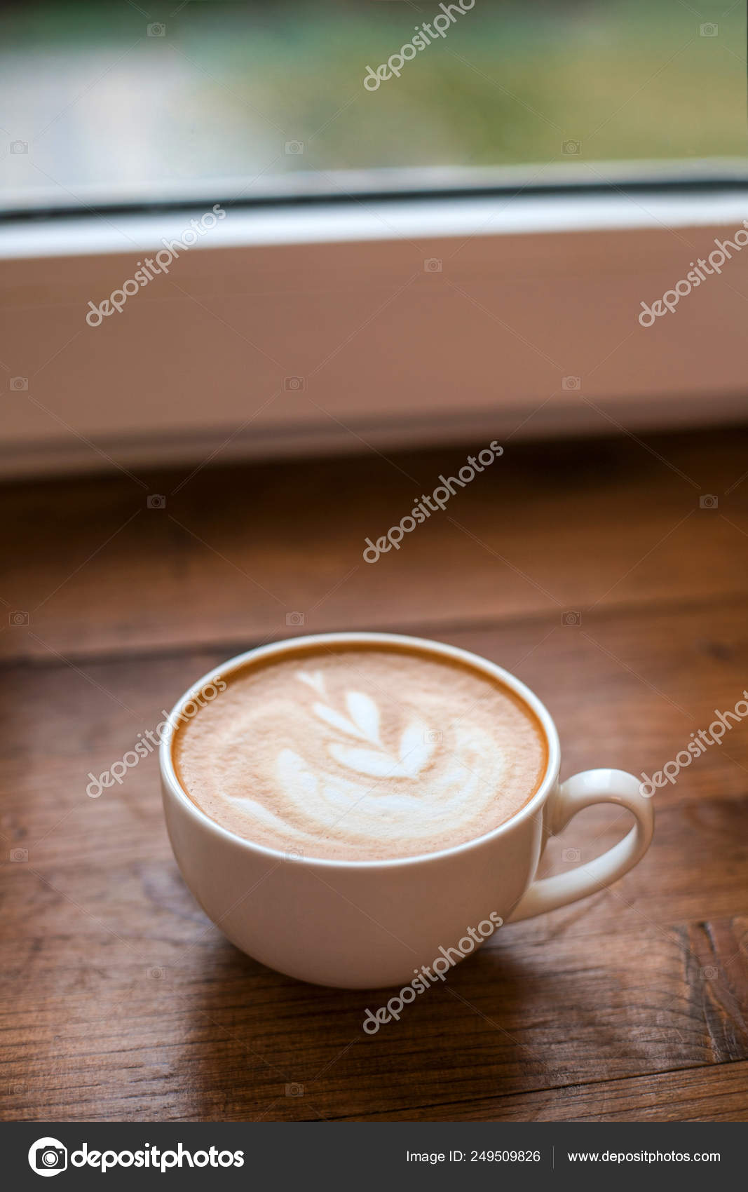 Cup of latte art at wooden background. Stock Photo by ©ezhenaphoto