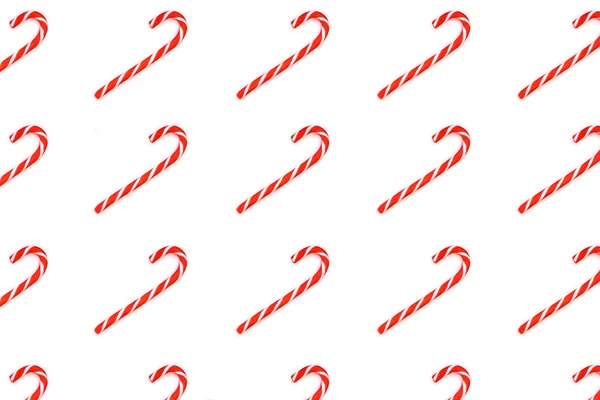 Pattern made from Christmas candy canes isolated on white.