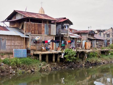  Irmak kenarına, saman evleri Manado, Sulawesi, Endonezya