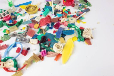 Microplastics collected on the beach. Plastic pollution concept. clipart
