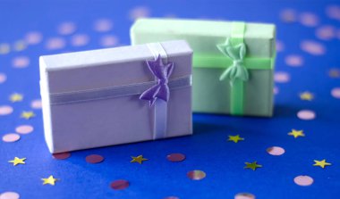 Two boxes with gifts on a blue background. clipart