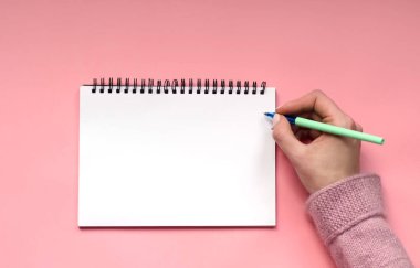 Pembe bir arka plan üzerinde yazmak için beyaz Not defteri.
