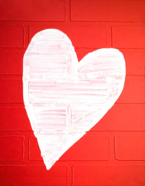 White heart painted on a red brick wall