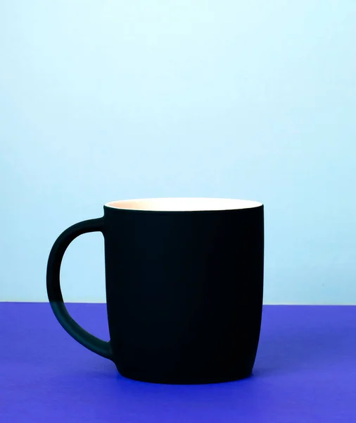 New black Cup on solid pastel background. — Stock Photo, Image