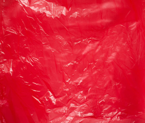 Red plastic bag close-up. Bright shiny background.