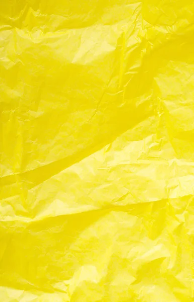Gelbes zerknülltes Papier in Großaufnahme. heller Hintergrund. Textur — Stockfoto