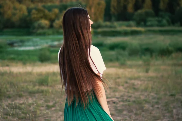 A beautiful girl with dark long hair. Summertime — Stock Photo, Image