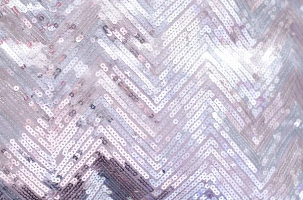 Fabric texture with shimmering silver sequins. Background with sequins.