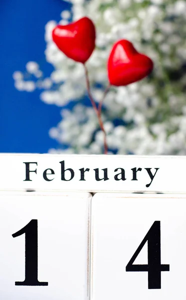 Calendar with the date of the holiday Valentine\'s Day and two hearts. Holiday of all lovers.