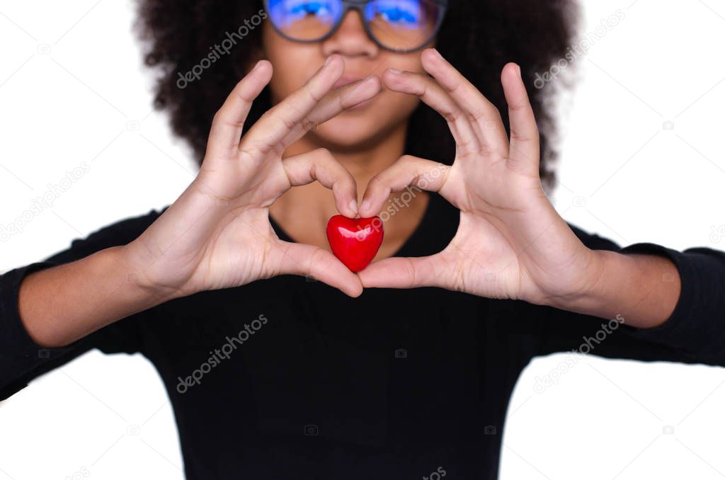 Dark-skinned curly girl holding a red heart. Valentine's Day February 14th