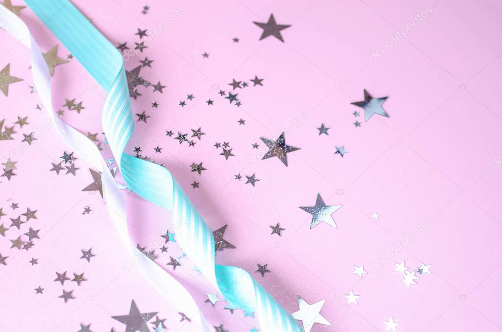 Pink festive background with stars and ribbons.