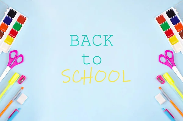 Back to school banner with stationery and blue background.
