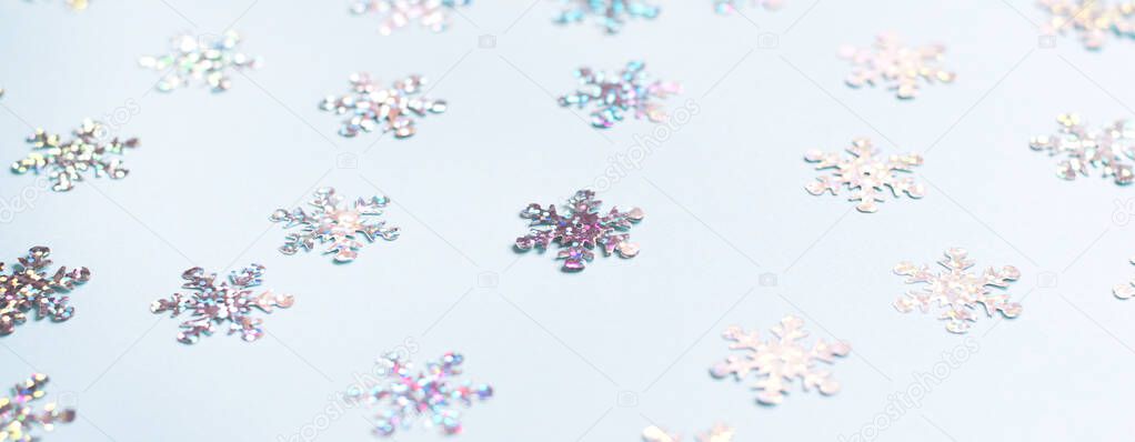 Many shimmering snowflakes on a blue background. 