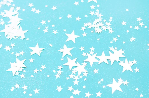 Licht blauwe achtergrond met veel glanzende sterren. — Stockfoto