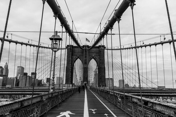 Looking along the paths of Brooklyn Bridge in symmetry - black and white