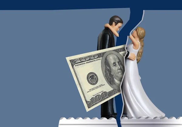 To illustrate how money issues can come between couples and cause divorce, a one hundred dollar bill comes between a bride and groom wedding cake topper. This is a photo-illustration.