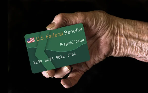 Elderly citizens can receive federal benefits in the form of a debit card. Federal  benefits for Social Security, SSI, VA  and more can be paid using a prepaid debit card. Here is a mock prepaid government debit card in an elderly woman\'s hand.